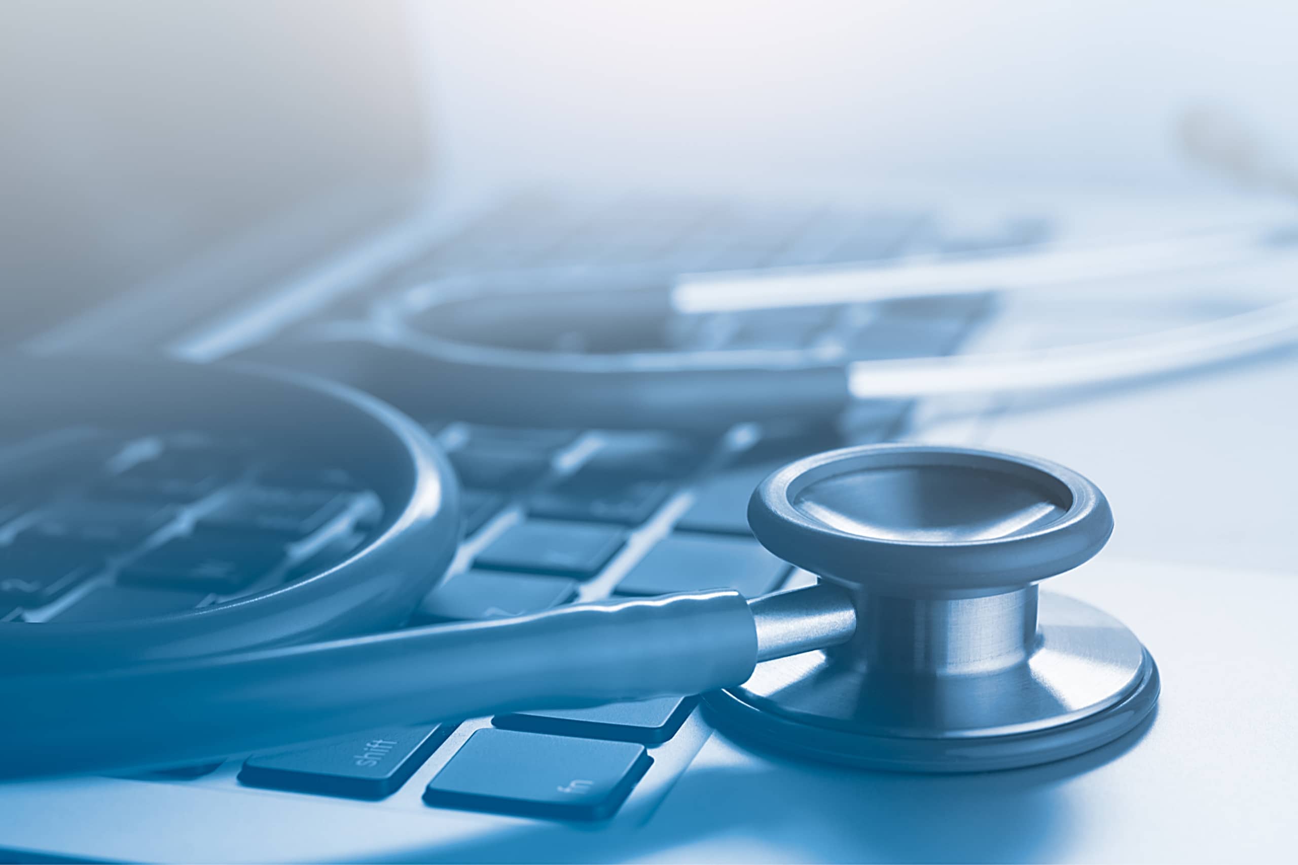 picture of a stethoscope on a laptop at a healthcare organization experiencing medical coding staffing shortages
