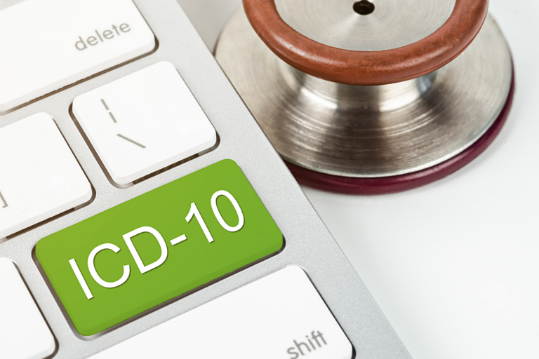a green button on a computer keyboard showing mra icd-10 medical coding support for healthcare organizations