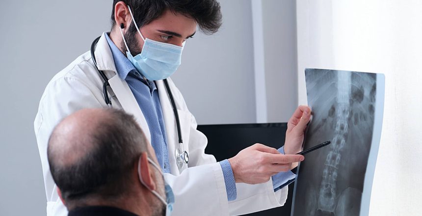 surgeon showing a spinal surgery x-ray with supporting medical coding information to a patient